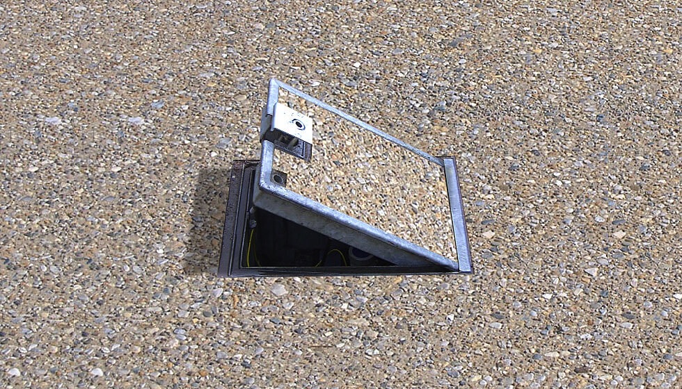 A flip-lid in-ground service unit which provides safe, easy access to power and other services in public outdoor spaces.